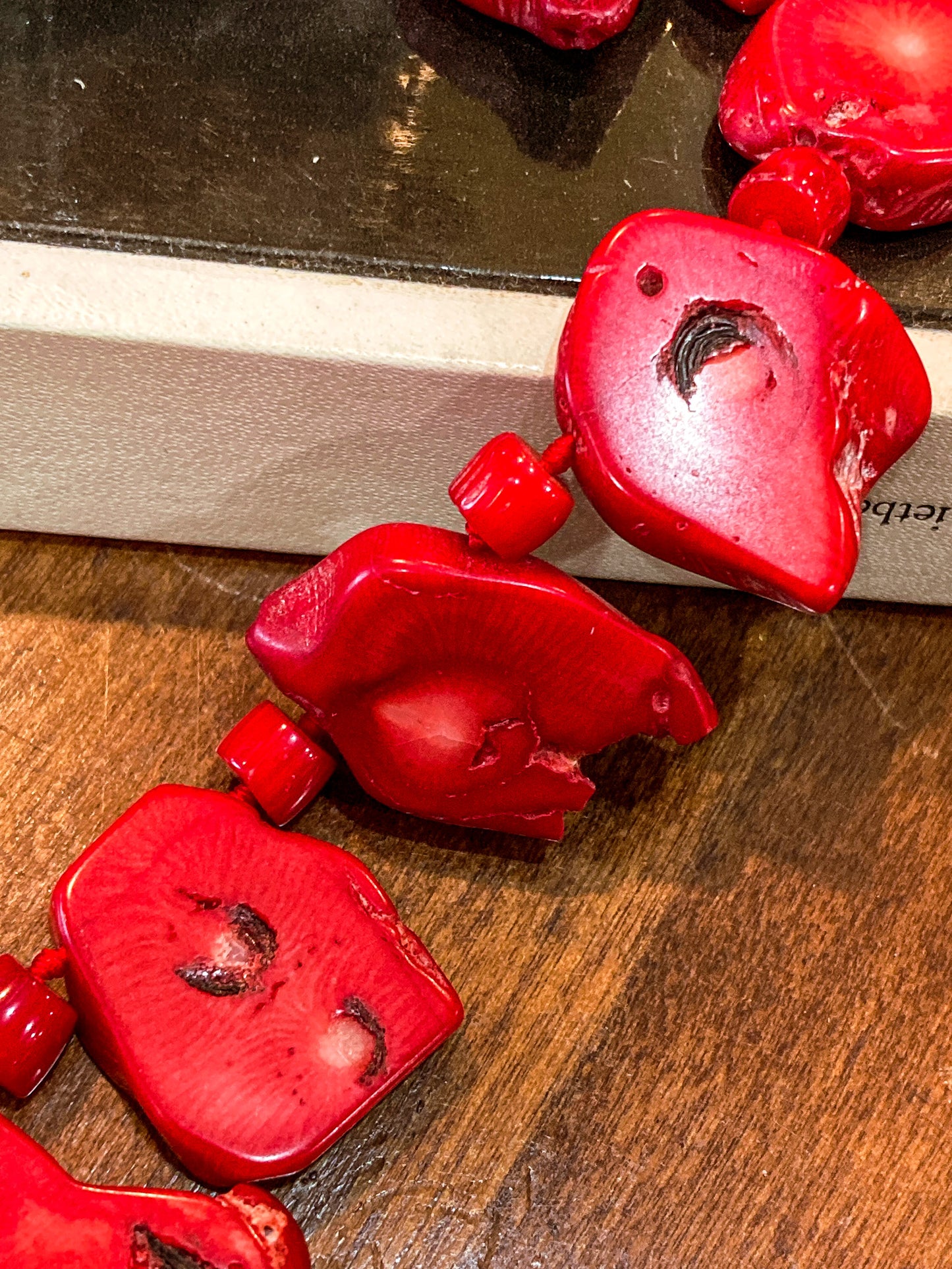 Bold LUC Lucas Lameth Red Coral Stone Graduated Bead Sterling Silver Necklace on wood and book